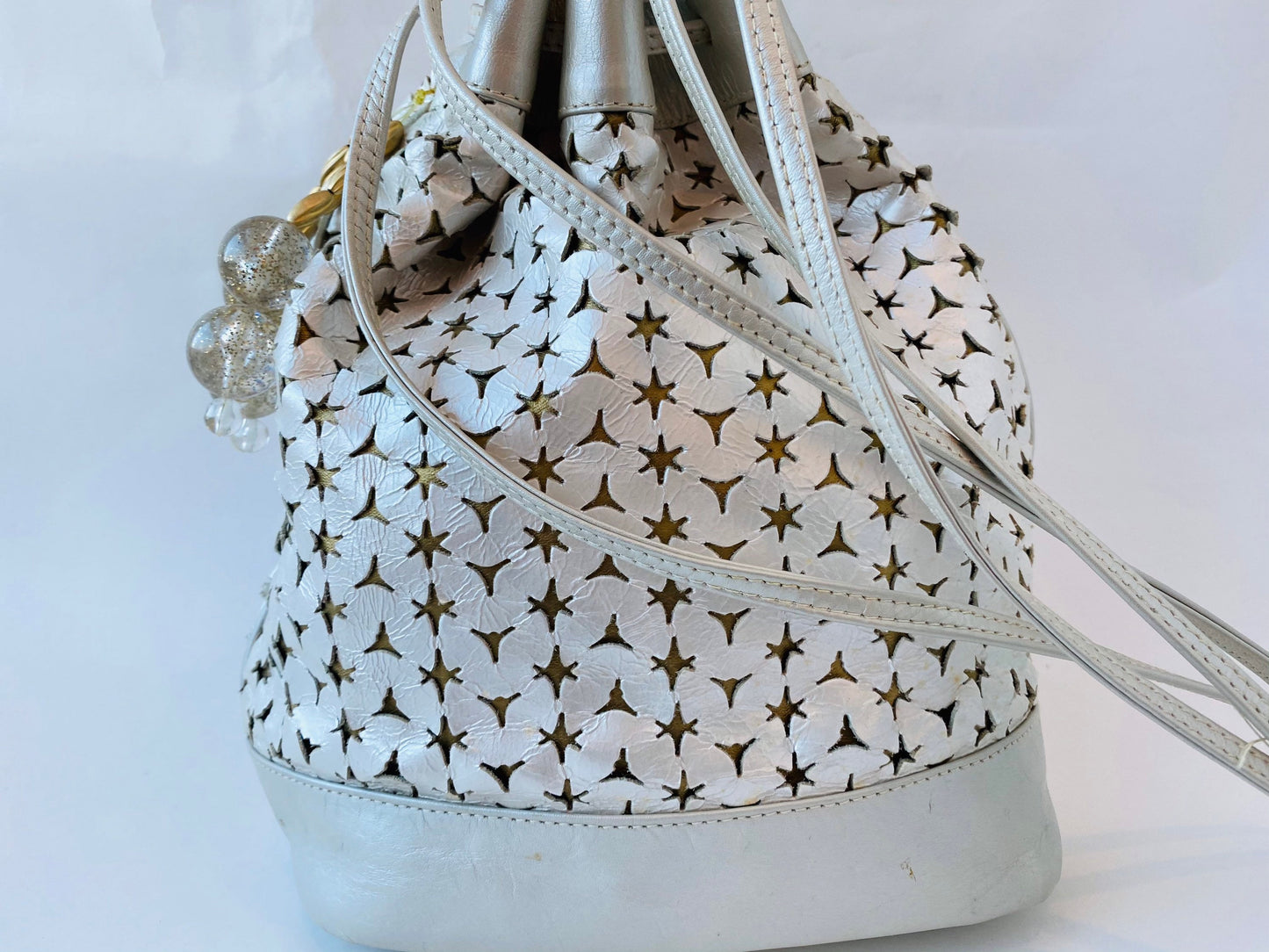 Neiman Marcus 80s Italian Metallic Gold and Pearl Leather Disco Star Perforated Tassels Drawstring Bucket Bag
