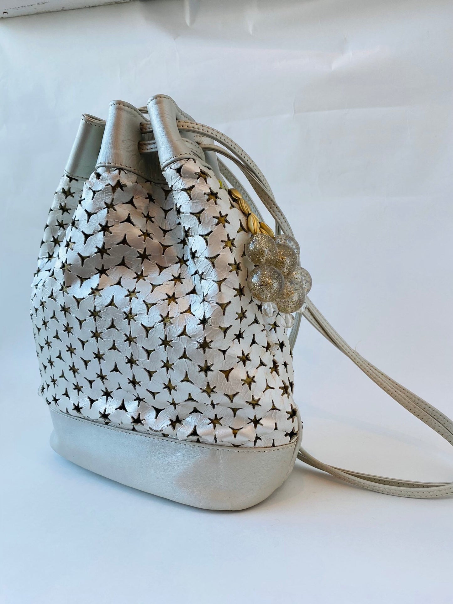 Neiman Marcus 80s Italian Metallic Gold and Pearl Leather Disco Star Perforated Tassels Drawstring Bucket Bag