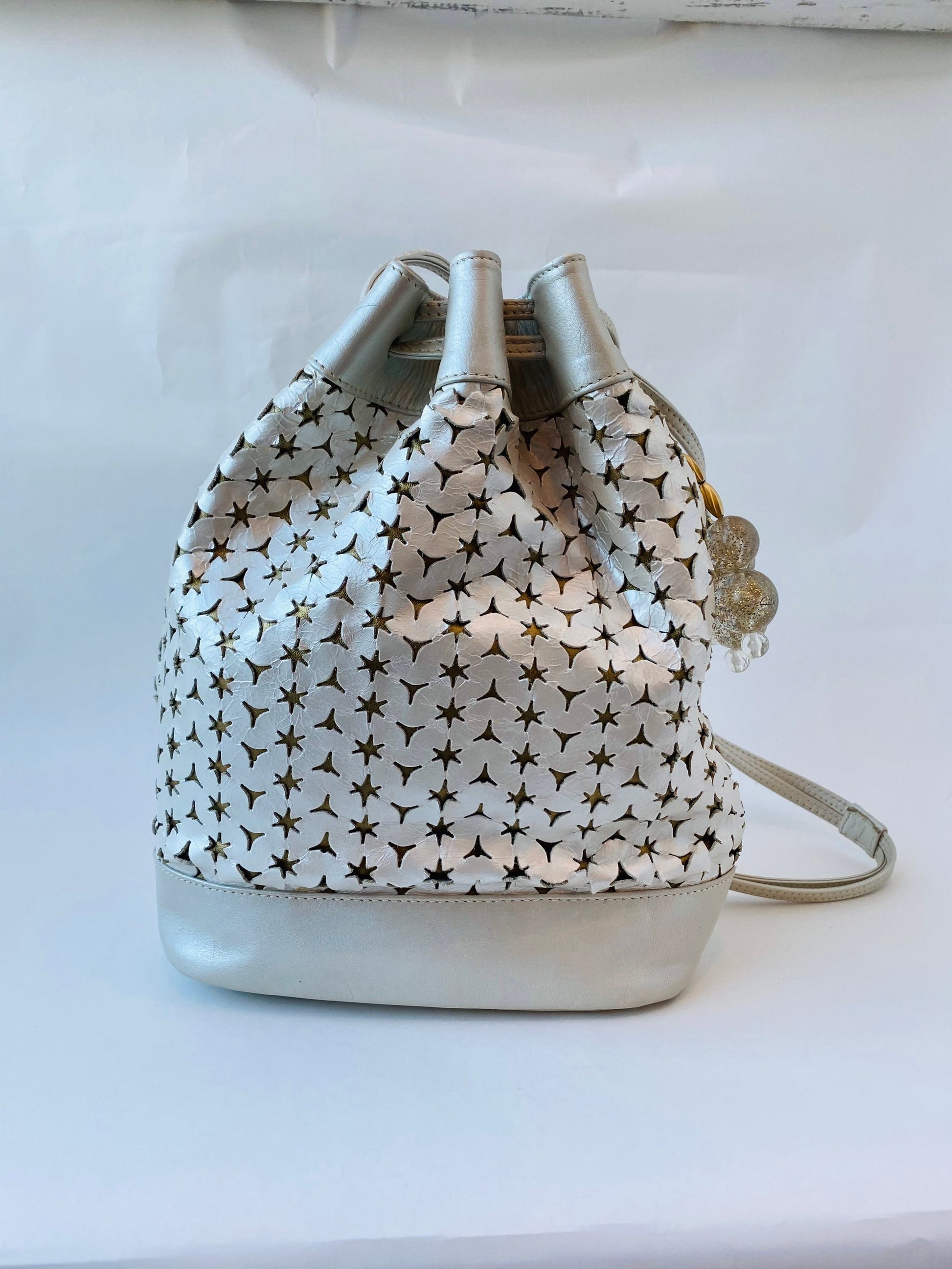Neiman Marcus 80s Italian Metallic Gold and Pearl Leather Disco Star Perforated Tassels Drawstring Bucket Bag