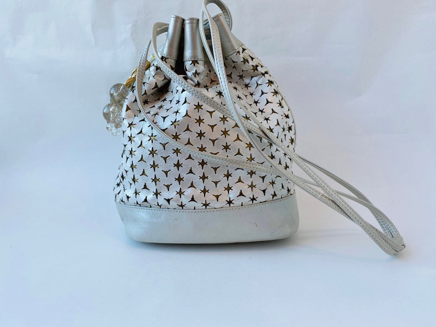Neiman Marcus 80s Italian Metallic Gold and Pearl Leather Disco Star Perforated Tassels Drawstring Bucket Bag