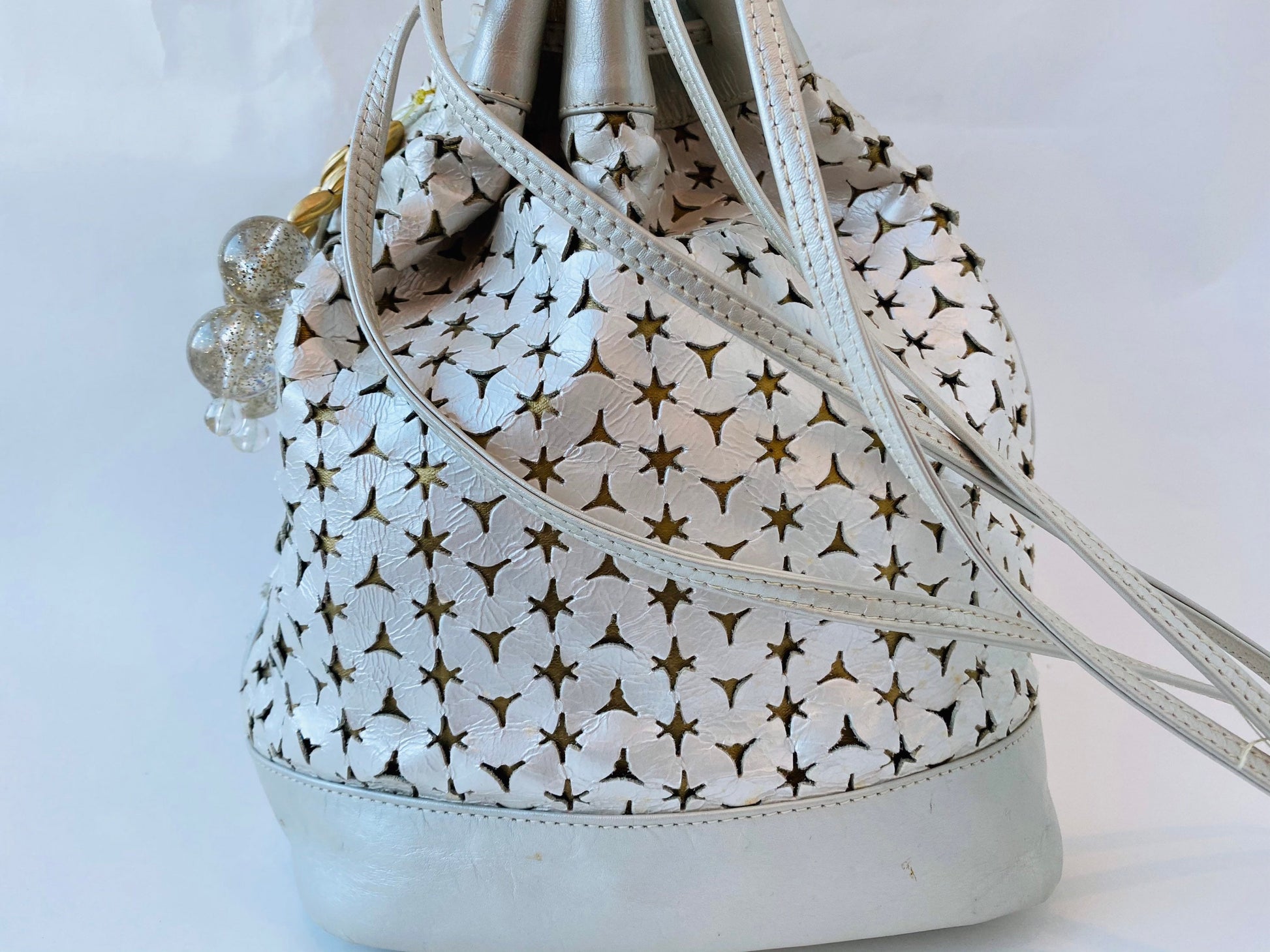 Neiman Marcus 80s Italian Metallic Gold and Pearl Leather Disco Star Perforated Tassels Drawstring Bucket Bag