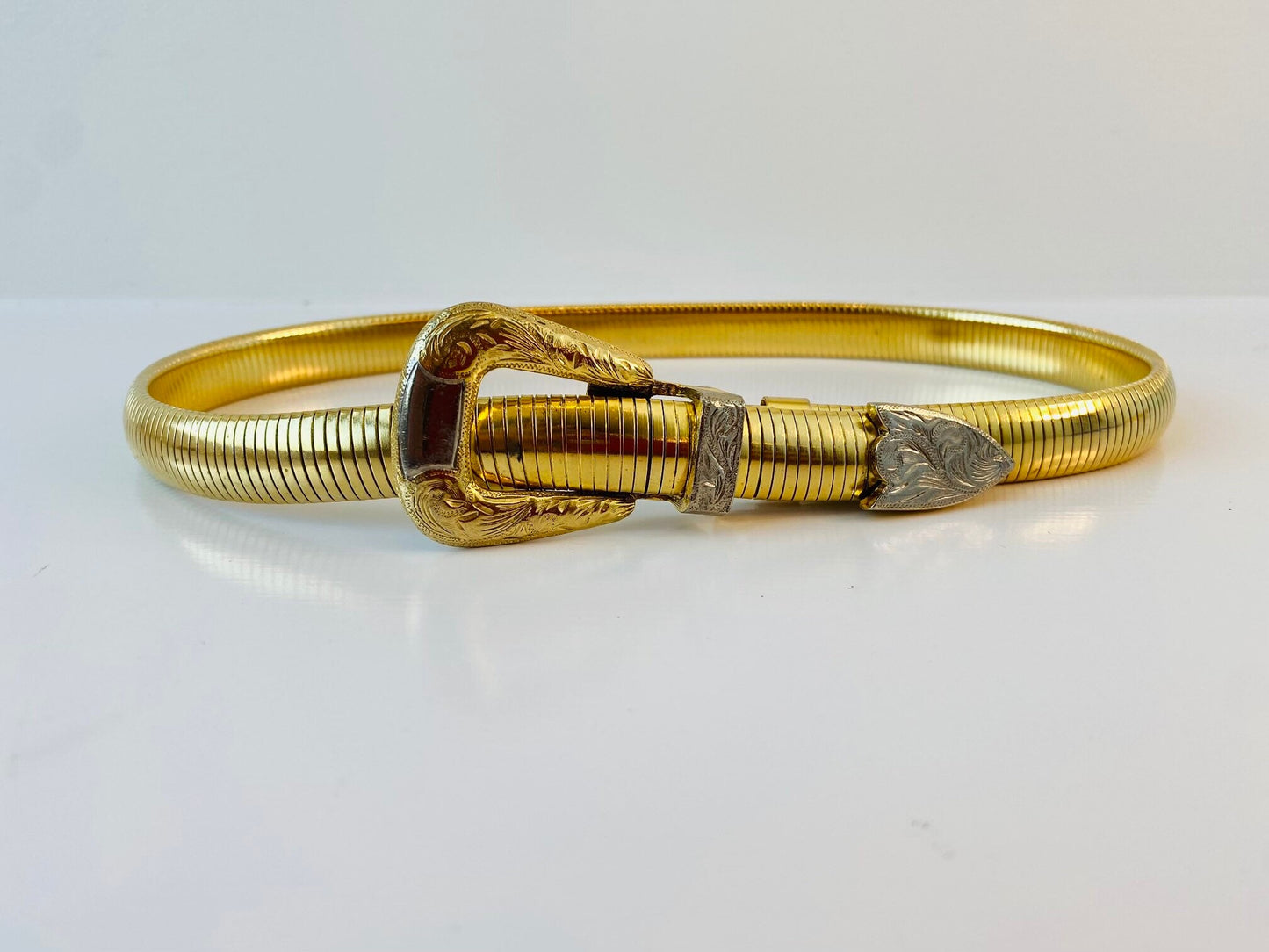 Vintage signed Accessocraft NYC gold stretchy snake chain western metal buckle belt.