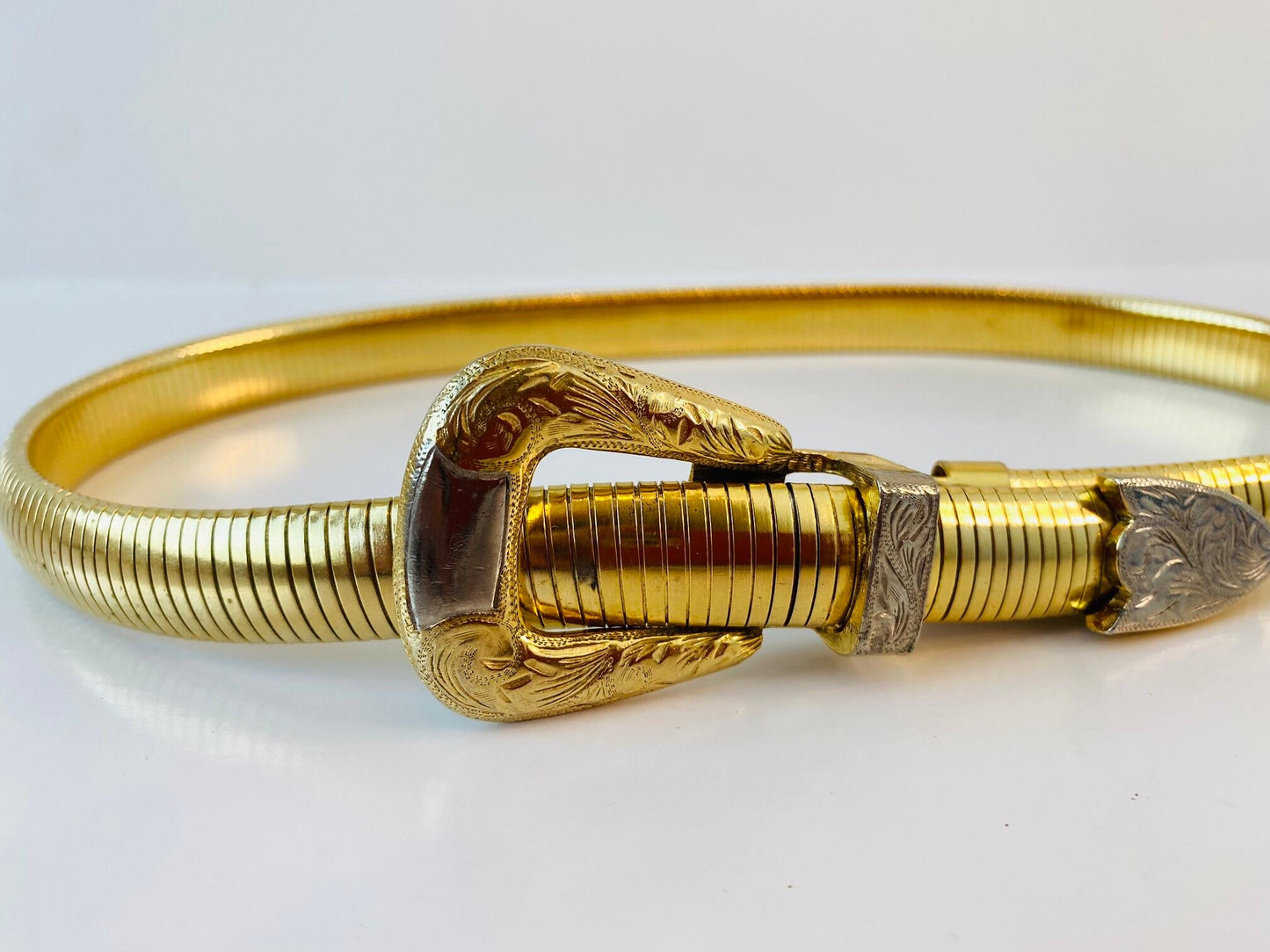 Vintage signed Accessocraft NYC gold stretchy snake chain western metal buckle belt.