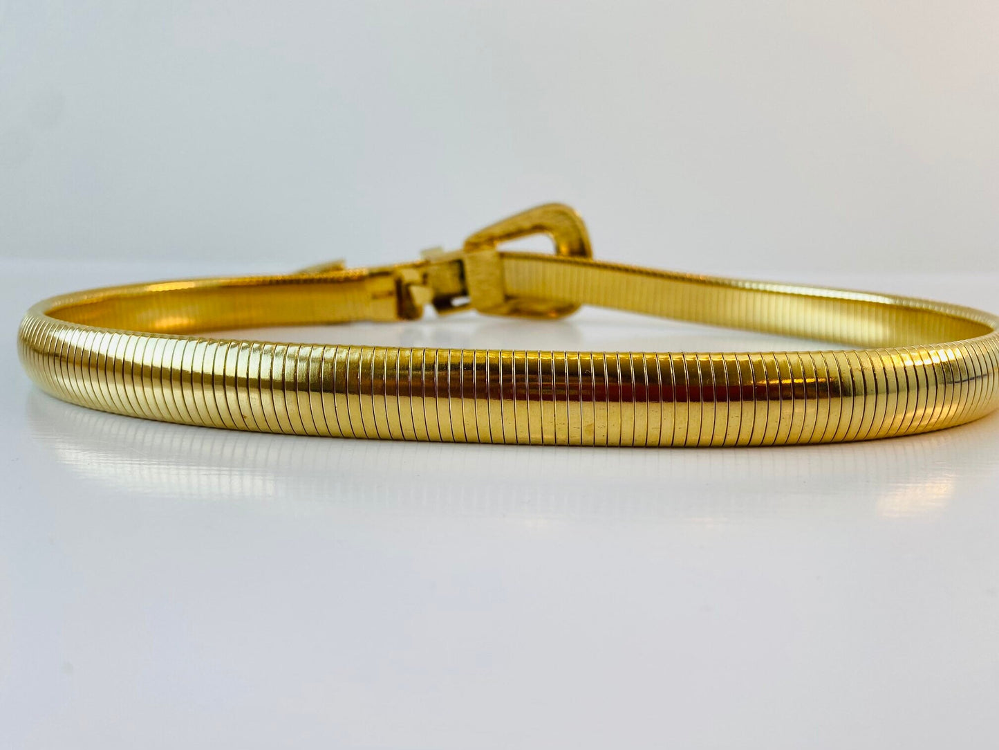 Vintage signed Accessocraft NYC gold stretchy snake chain western metal buckle belt.