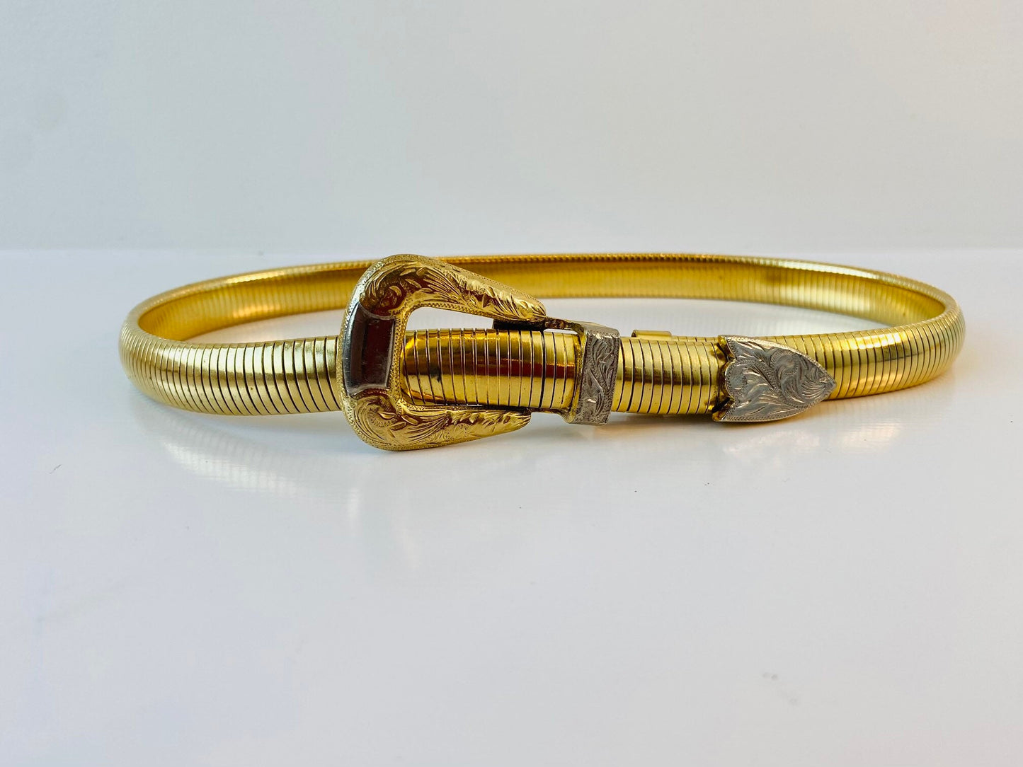 Vintage signed Accessocraft NYC gold stretchy snake chain western metal buckle belt.